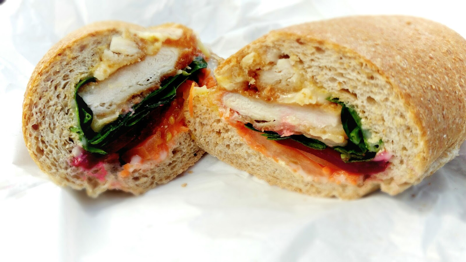 Sandwich halves with fresh greens and tomato from the cafe's Google Maps food gallery