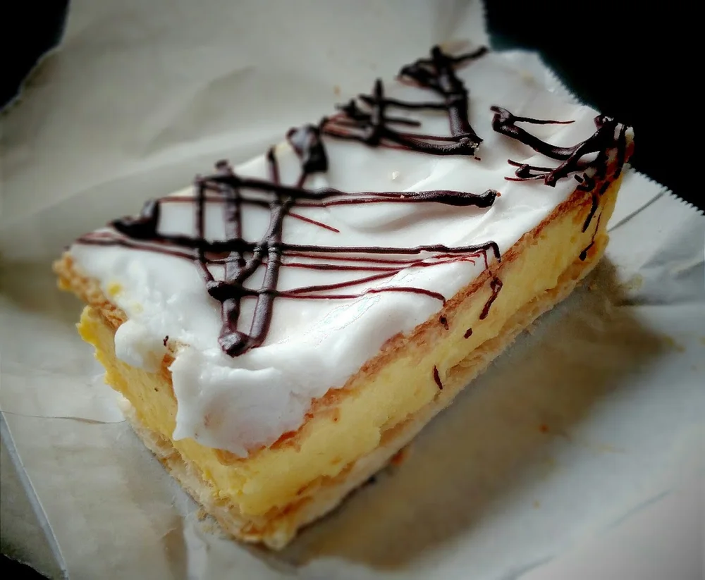 French vanilla slice topped with chocolate drizzle, from the cafe's Google Maps listing